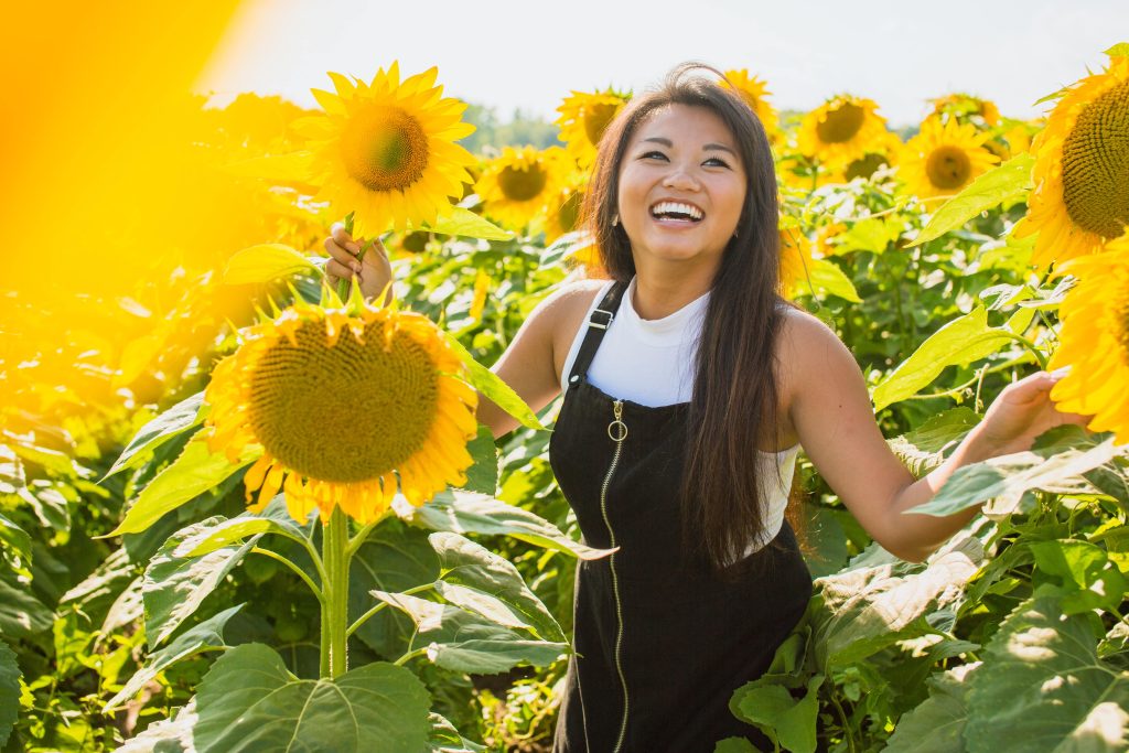Women Smiling In Sun Flower Field